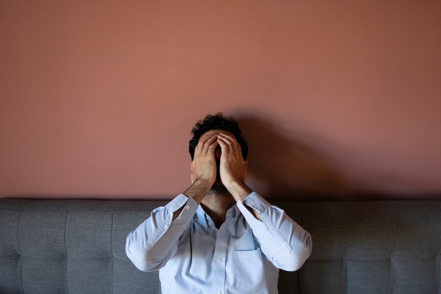 frustrated-man-couch-front-view_23-2149729608